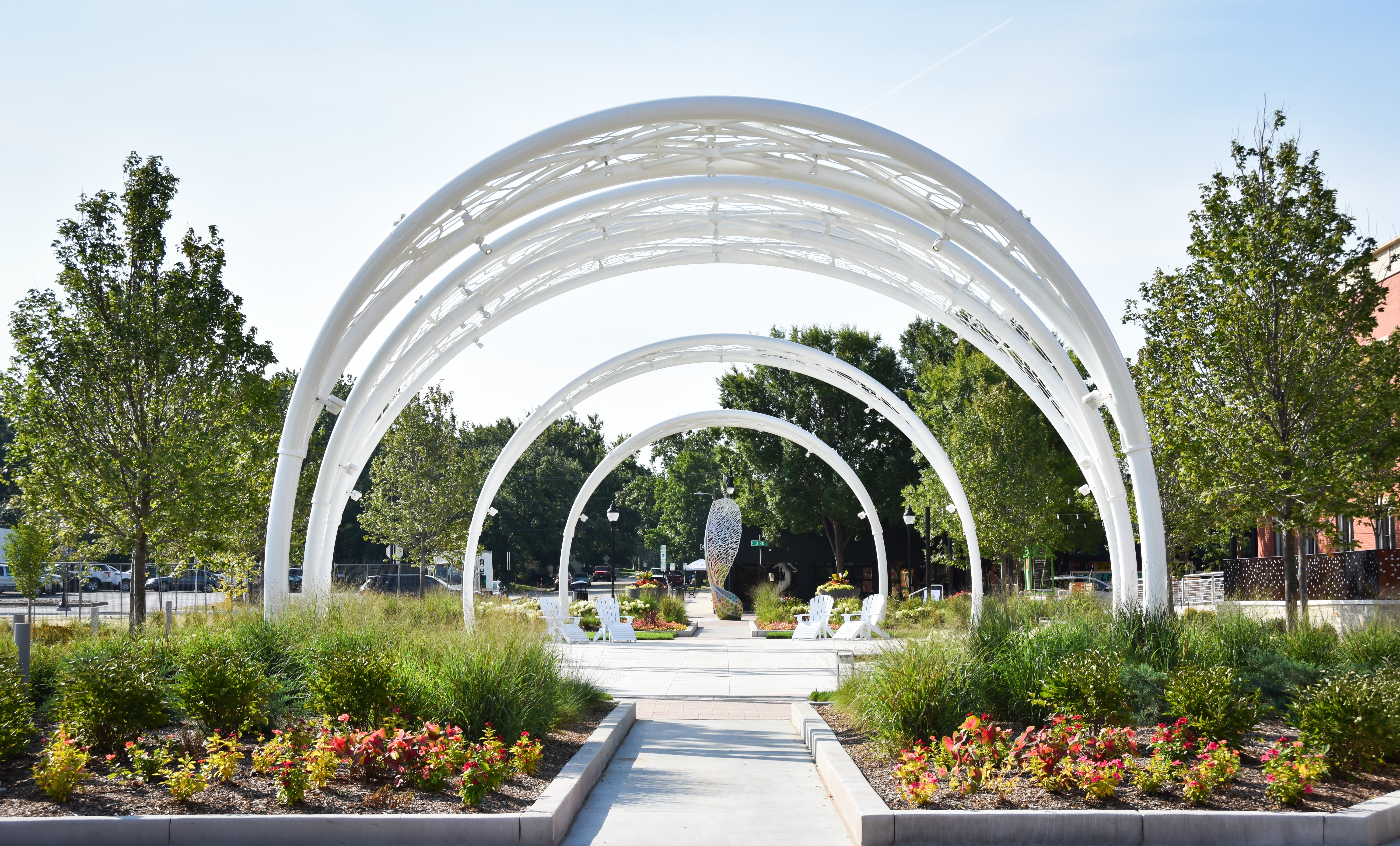 outdoor image of large white wickets with a maple seed sculpture in the background